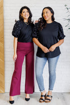 Diamonds and Pearls Puff Sleeve Top in Black worn with wine colored Dear Scarlett pants and Judy Blue jeans