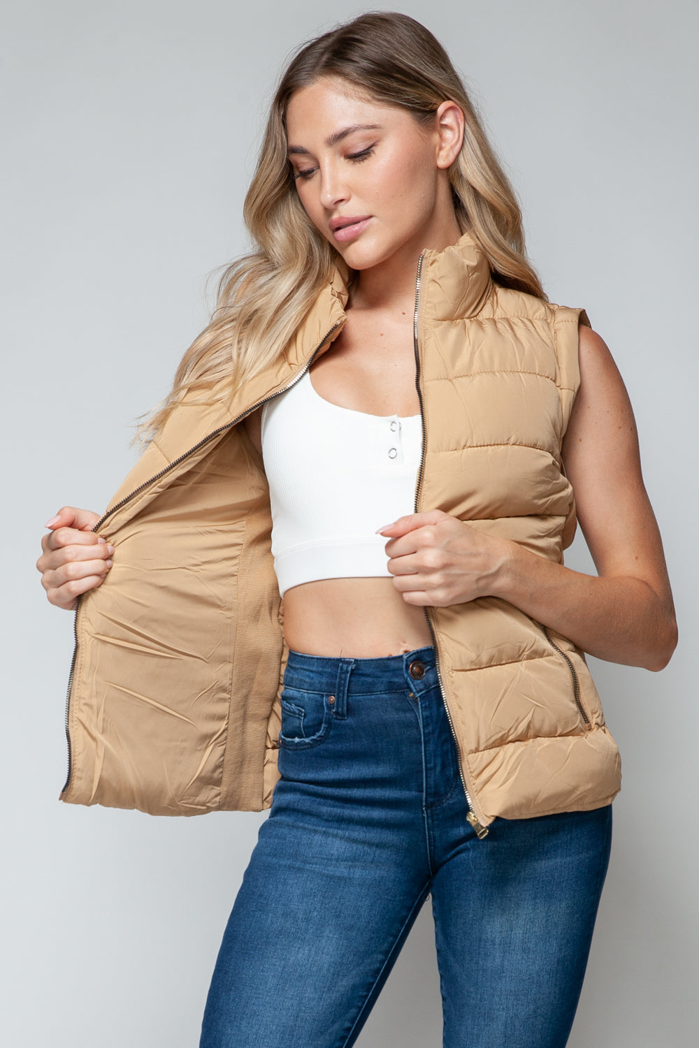 Sleeveless Tan puffer vest with zip front and side pockets