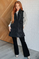 Black zip up puffer vest on Sarah size small with long sleeve striped top and black Judy Blue jeans