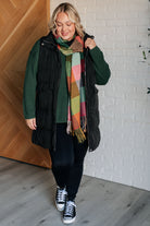 Long Puffer vest on Jordan styled with scarf and green sweater