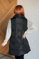 Back of light puffer vest in black