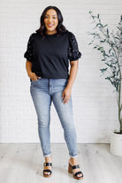 Diamonds and Pearls Puff Sleeve Top in Black on Krychele wearing Judy Blue skinny jeans