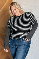 Black and white striped long sleeve top with accent stripe sleeves on Jordan