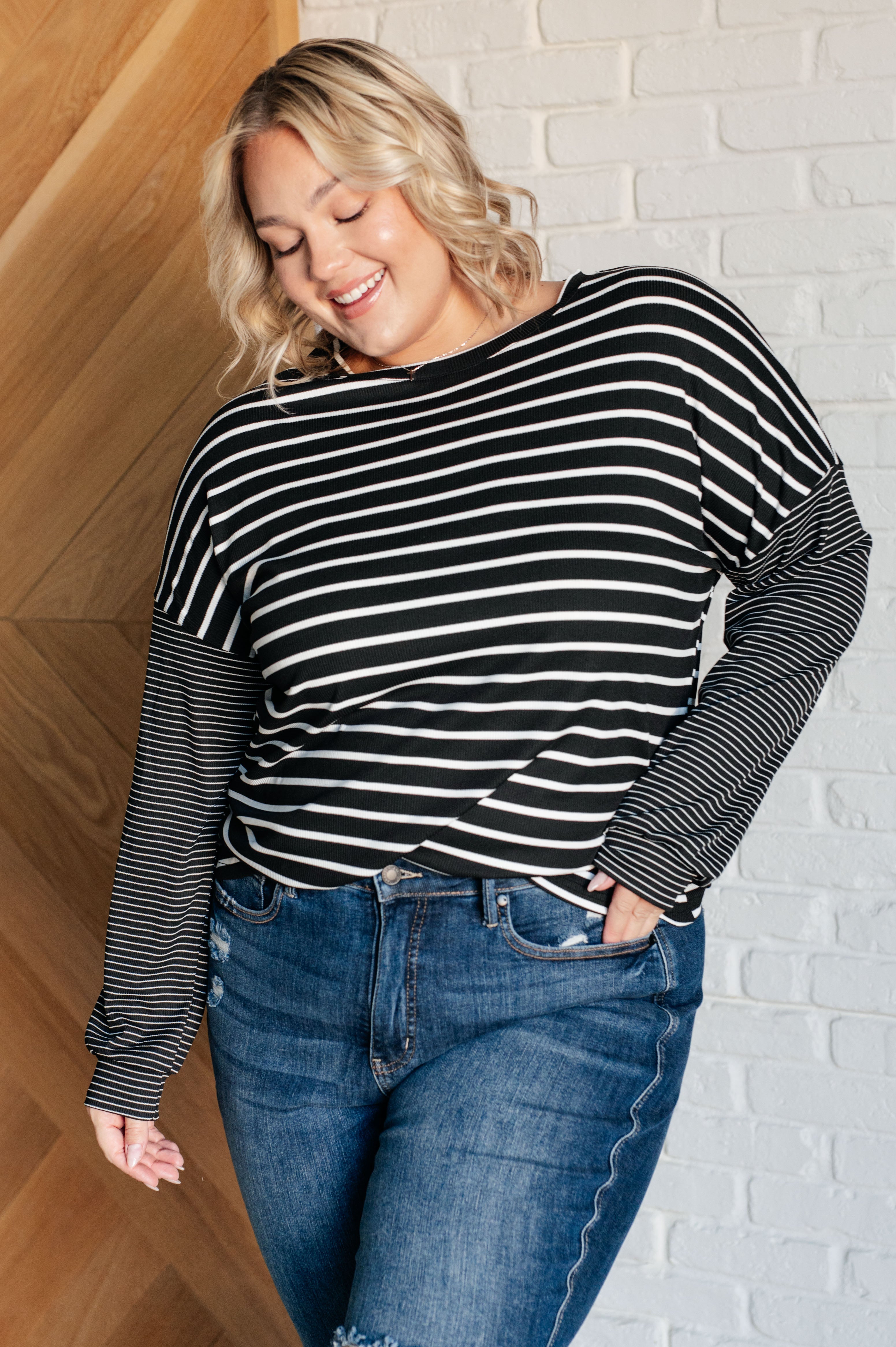 Black and white striped long sleeve top with accent stripe sleeves on Jordan