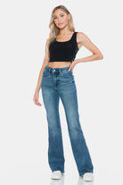 Judy Blue Mid Rise Tummy Control Cut Hem Flare Jeans in Vintage Wash on model